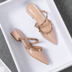 Beige stud-strap mules with pointed toe and low block heel, side buckle detail