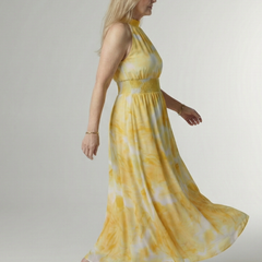 Yellow tie-dye halter midi dress with smocked waist and flowing gathered skirt
