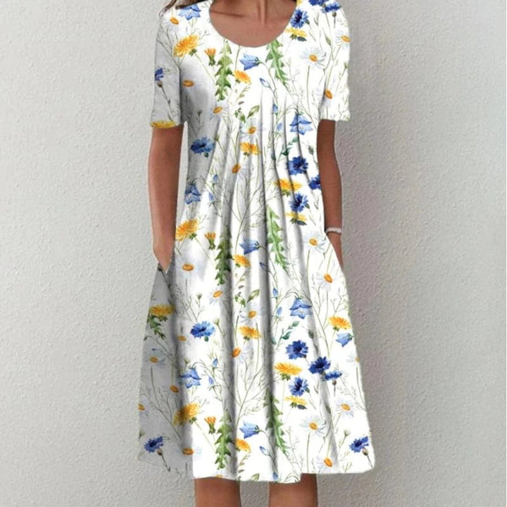 White floral dress with scoop neck, short sleeves, gathered tiered skirt
