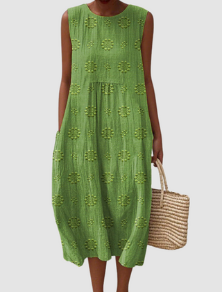 Green sleeveless midi dress with embroidered eyelet clover pattern, tiered skirt