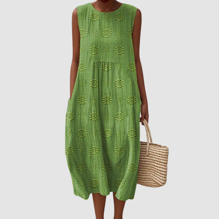 Green sleeveless midi dress with embroidered eyelet clover pattern, tiered skirt