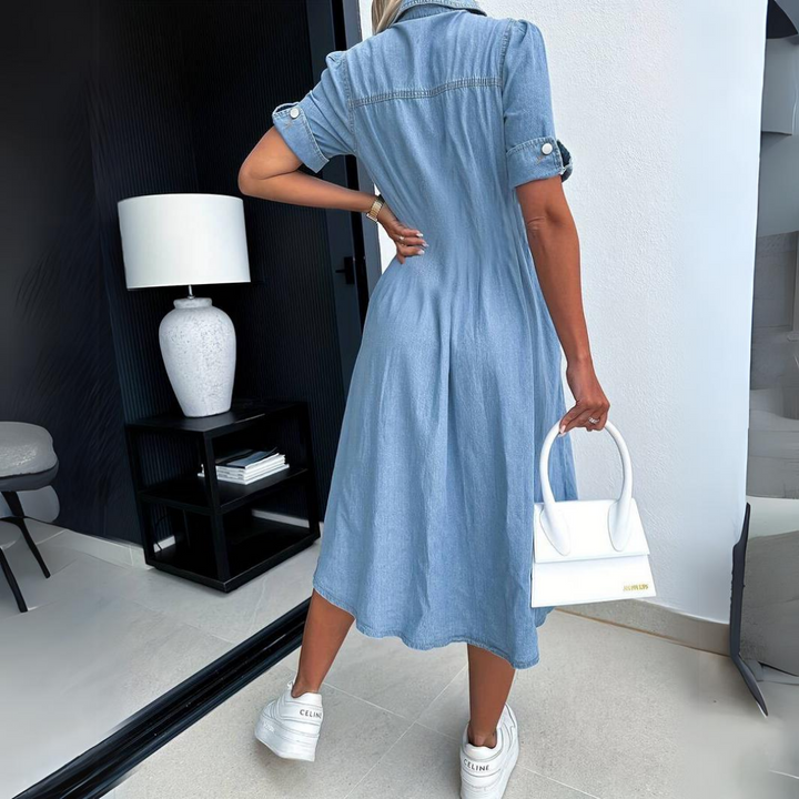 Light blue denim midi dress from back view with gathered yoke and short sleeves