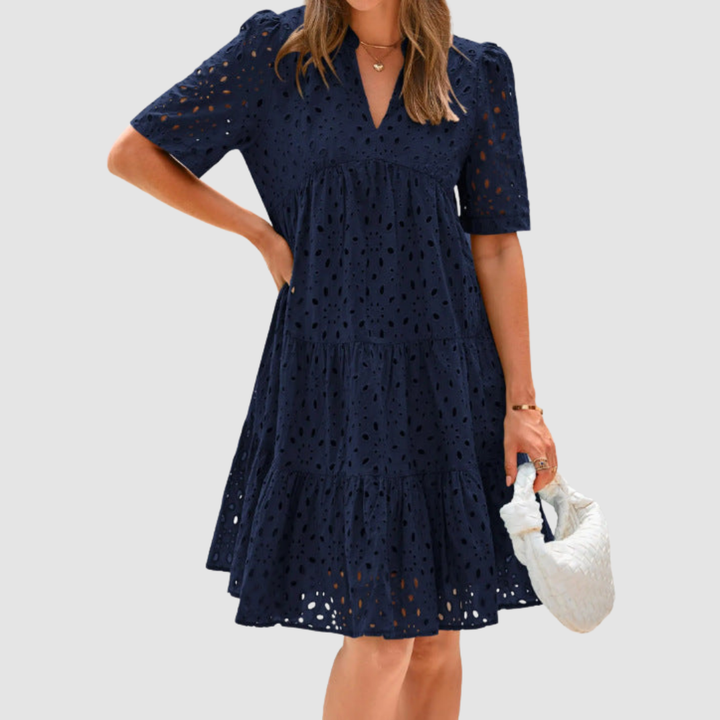 Navy V-neck tiered babydoll summer dress, short sleeves, dotted pattern.