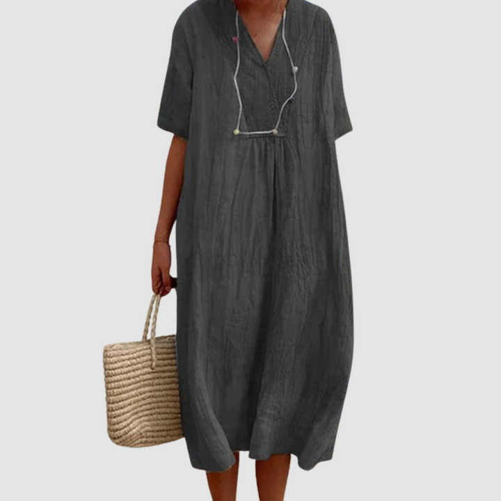 Black bohemian dress with V-neck, short sleeves, gathered waist, flowy midi