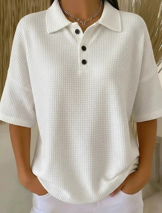 White waffle knit polo blouse with short sleeves, pointed collar, three-button placket
