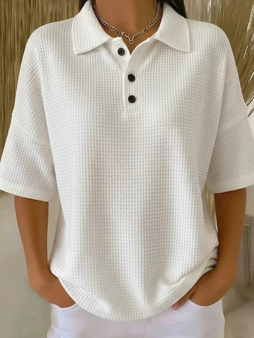 White waffle knit polo blouse with short sleeves, pointed collar, three-button placket