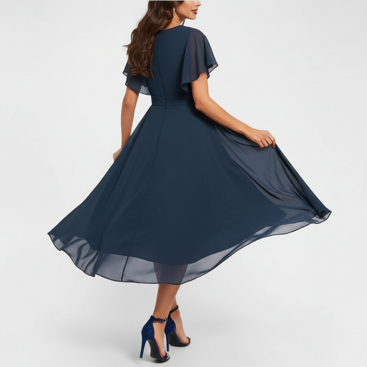 Flowing V-neck maxi dress in dark navy with flutter cap sleeves and full skirt