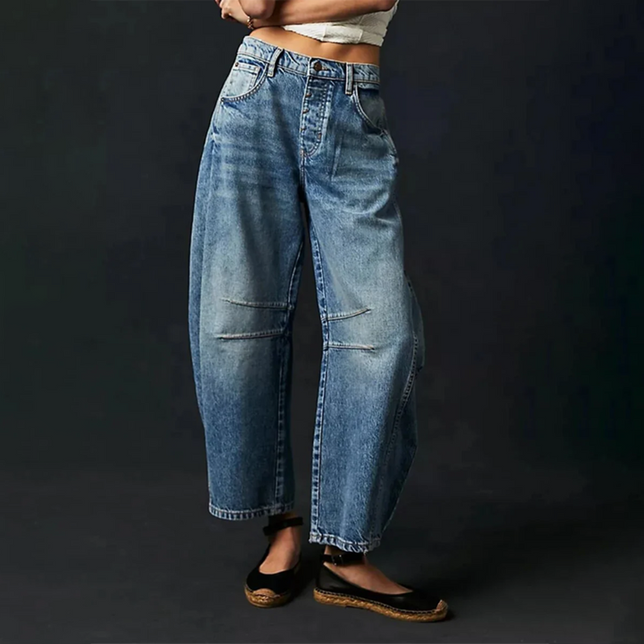 Medium blue wide-leg denim jeans with belt loops, button closure, and front patch pockets.