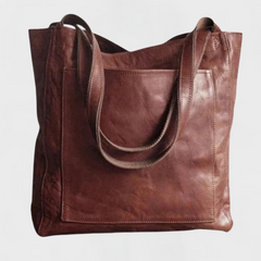 Dark brown leather tote bag with wide straps and front patch pocket