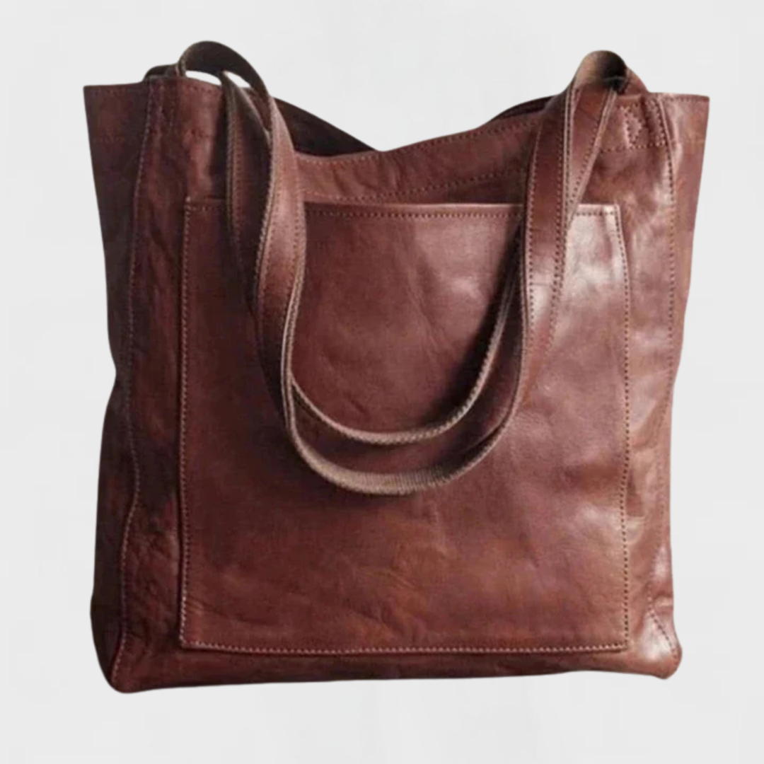 Dark brown leather tote bag with wide straps and front patch pocket