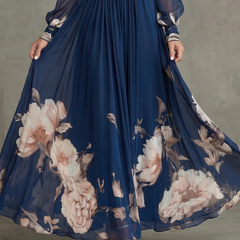 Navy pleated maxi skirt with large blush floral print and sheer long sleeves
