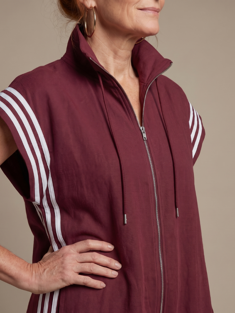 Burgundy sleeveless zip jumpsuit with white striped sleeve panels and drawstring hood