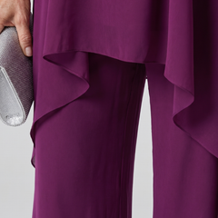 Purple halter tunic with asymmetric layered hem over matching wide-leg pants