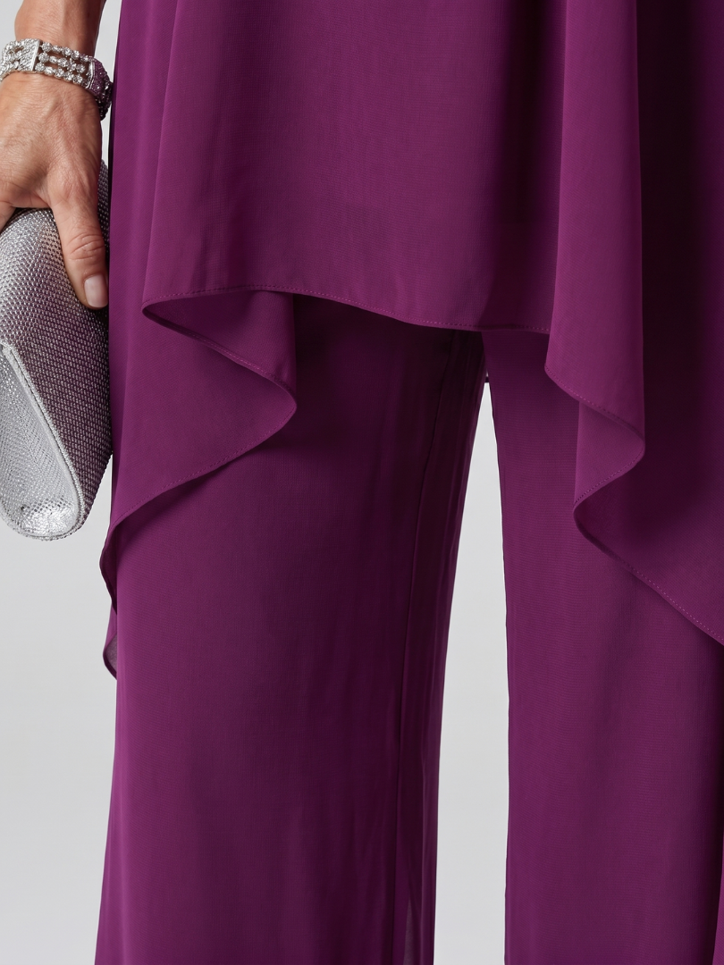 Purple halter tunic with asymmetric layered hem over matching wide-leg pants