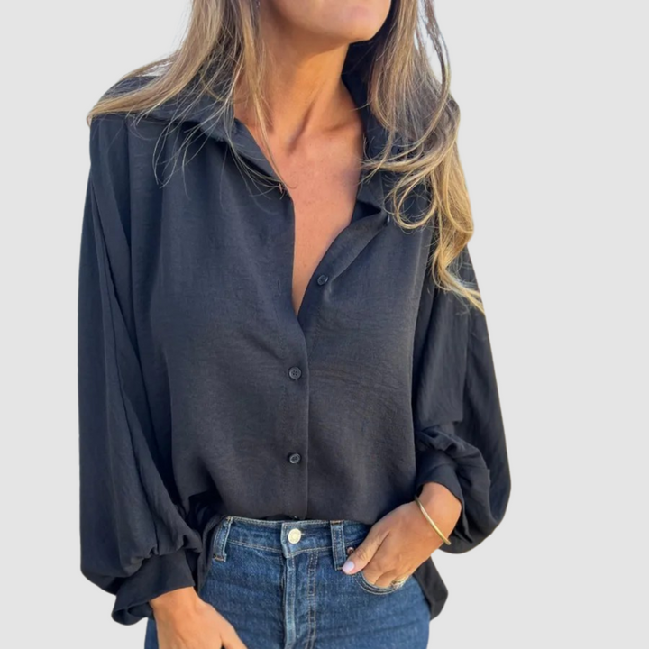 Oversized dark button-up blouse with collar and long cuffed sleeves, front buttons.