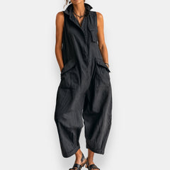 Black oversized sleeveless jumpsuit with open collar and oversized front cargo pockets