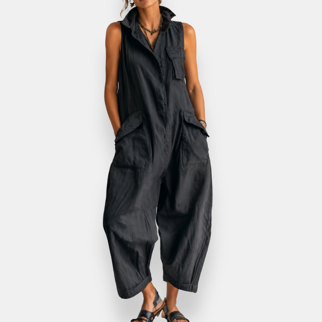 Black oversized sleeveless jumpsuit with open collar and oversized front cargo pockets