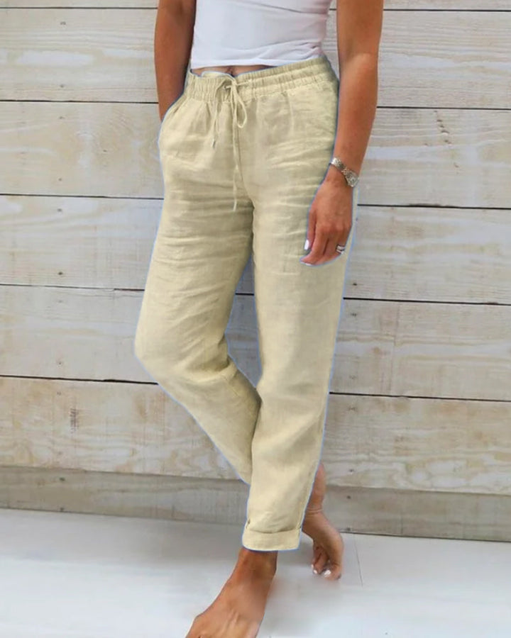Khaki cotton trousers with drawstring waist and tapered leg cuffs