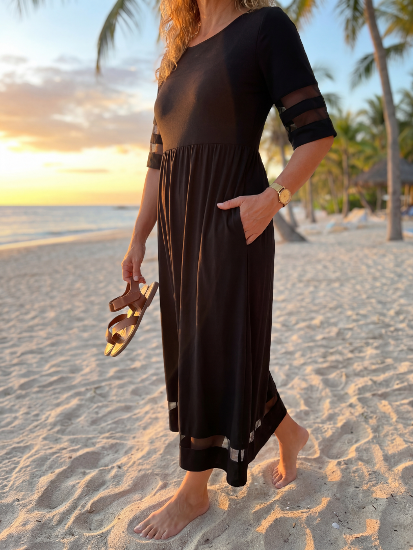 Black midi dress with short sleeves, tiered skirt and side pockets