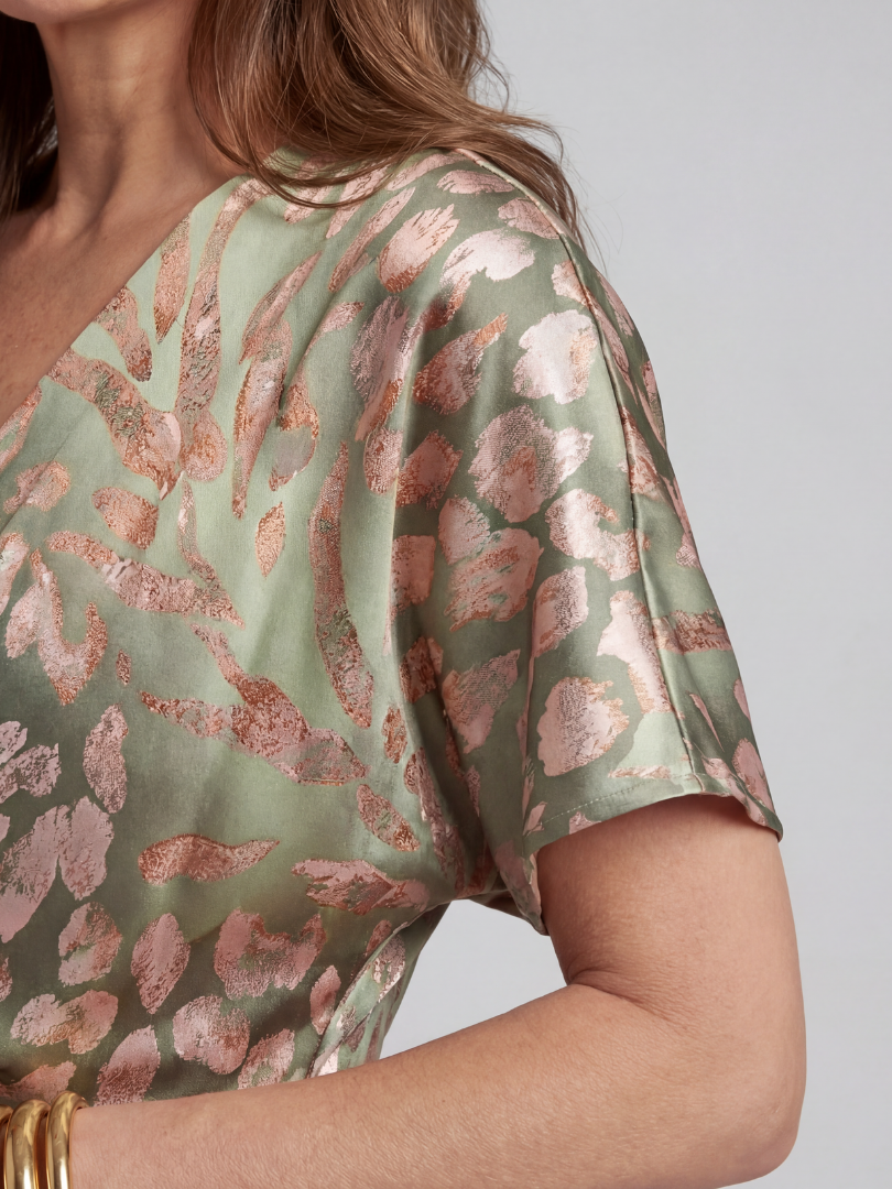 Back of green and blush abstract print midi dress, short sleeves.