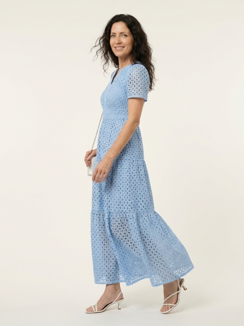 Sky blue V-neck tiered midi dress with short sleeves, side view, eyelet dot texture