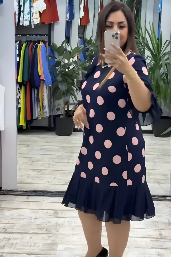 Navy midi dress with large pink polka dots and ruffled short sleeves