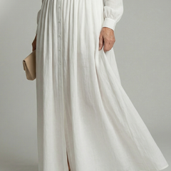 White maxi dress close-up: vertical button placket, gathered waist, lightweight fabric