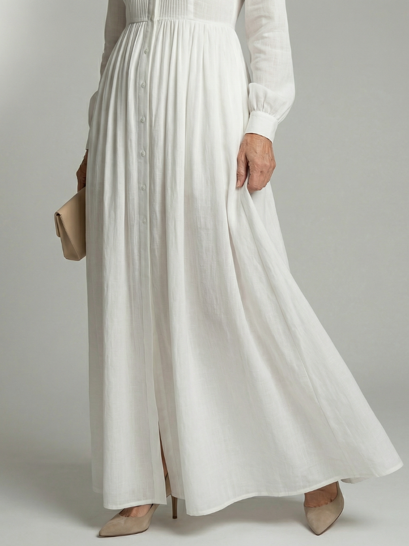 White maxi dress close-up: vertical button placket, gathered waist, lightweight fabric