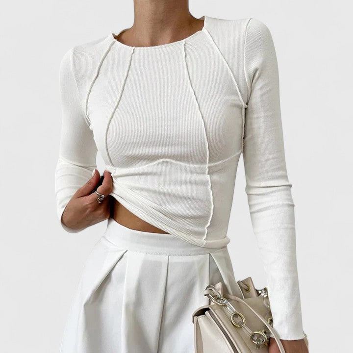 White long-sleeve knit top with crew neck and draped ruched front; fitted cropped hem