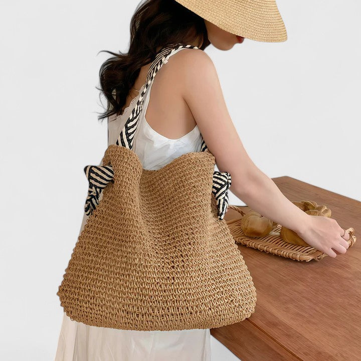Woven boho shoulder bag in warm brown with black-and-white striped strap accents