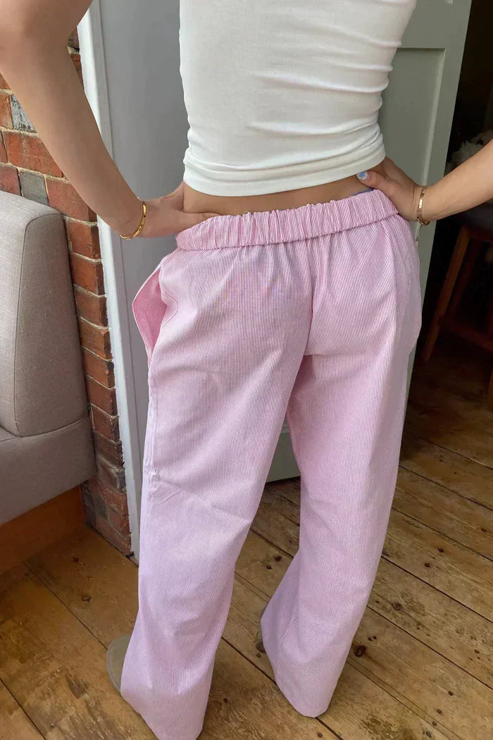 Pink lounge trousers with elastic waistband and wide relaxed fit, straight leg opening