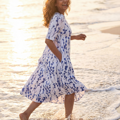 White floral midi dress, side view with short sleeves and flowing skirt