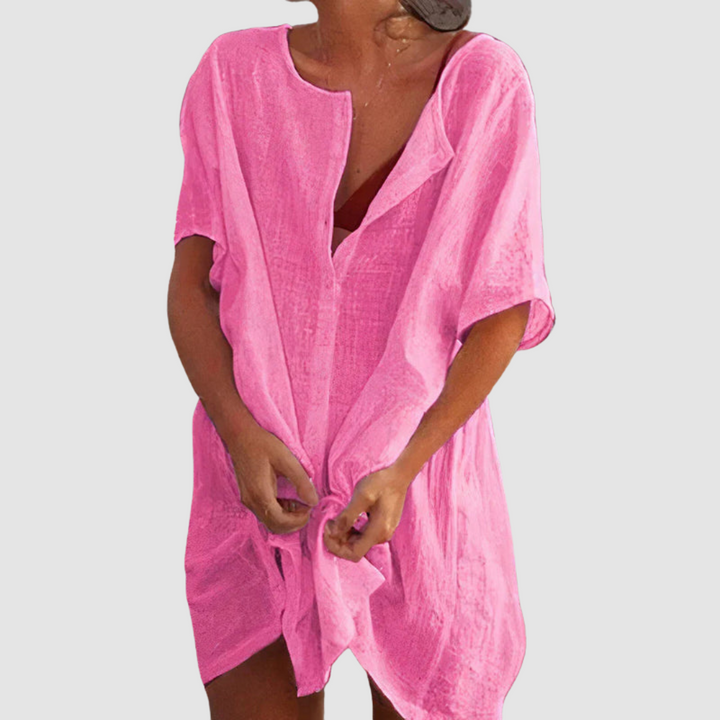 Pink soft loose fit dress with V-neck, short sleeves, and front tie knot.