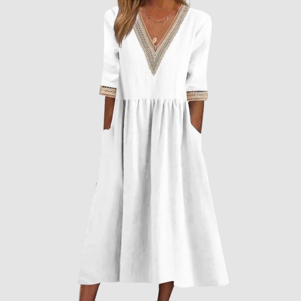 White mid-length dress with V-neck embroidered trim, 3/4 sleeves, and tiered skirt