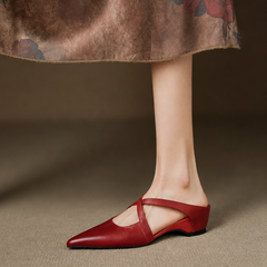 Red leather mules with pointed toe and slingback strap, low heel on model.