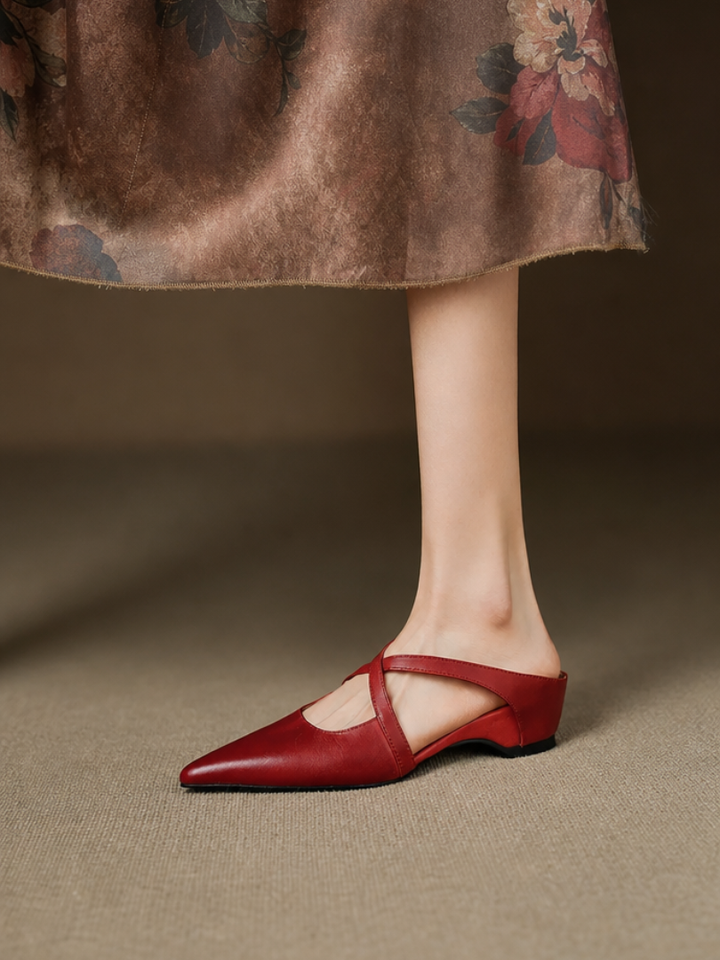 Red leather mules with pointed toe and slingback strap, low heel on model.
