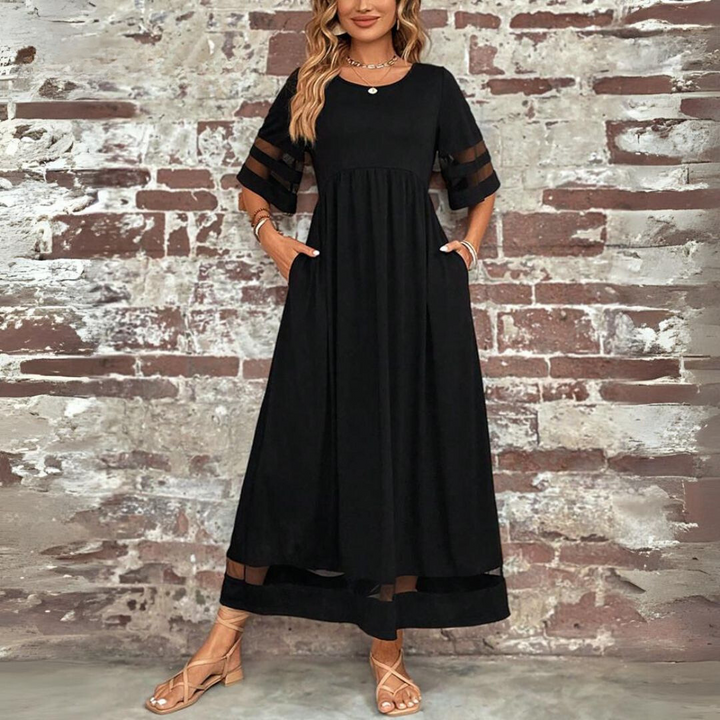 Black A-line midi dress with elbow sleeves, sheer stripe accents and tiered hem