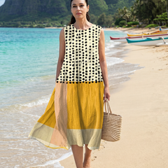 Sleeveless midi dress with black polka dots on cream bodice and yellow layered skirt