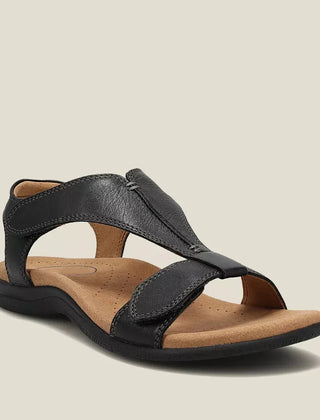 Black orthopedic sandals with wide cross strap and cushioned footbed