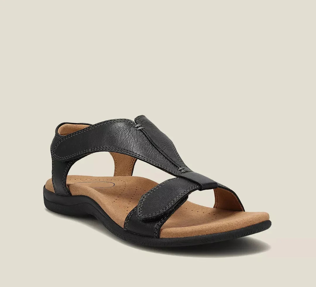 Black orthopedic sandals with wide cross strap and cushioned footbed