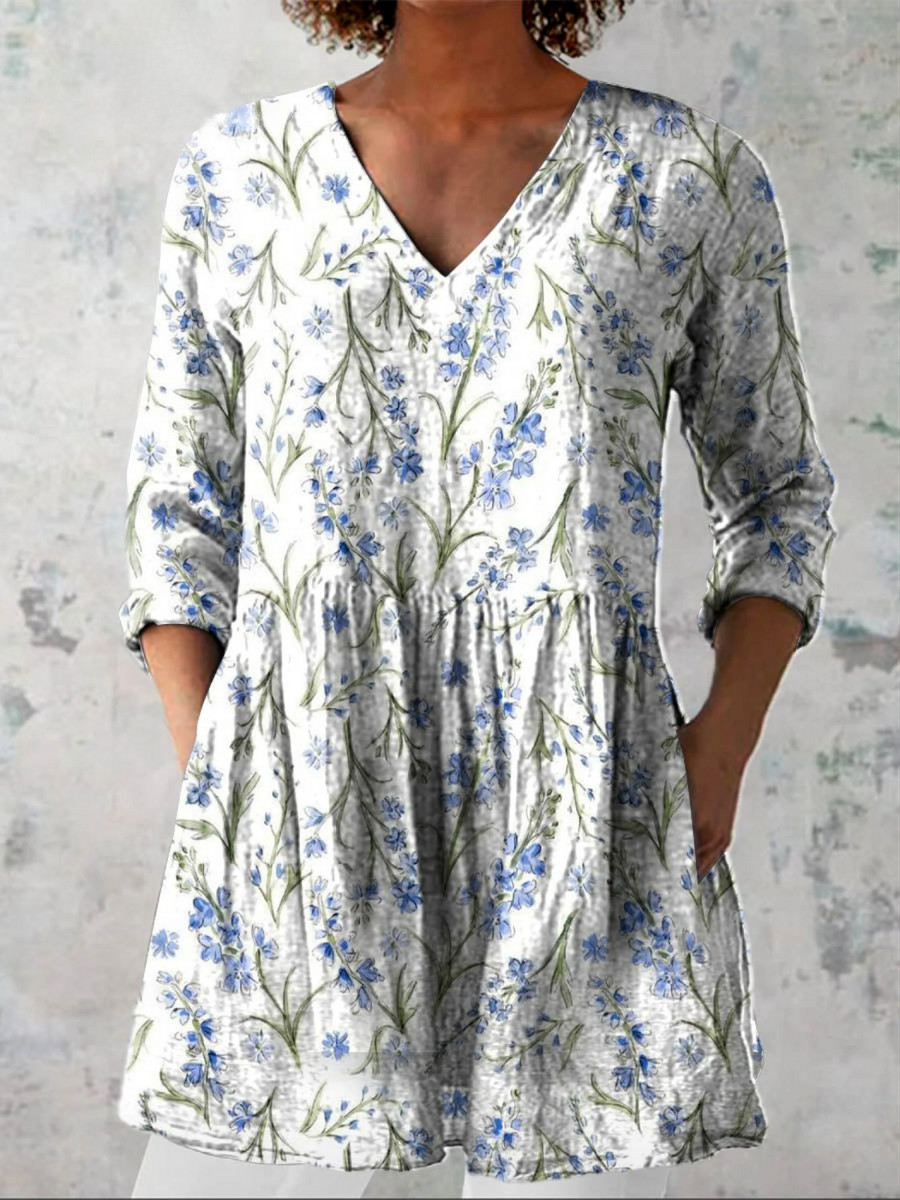 White long blouse with V-neck, 3/4 sleeves, and blue floral botanical print