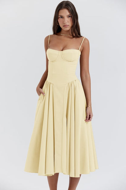 Light yellow corset sundress with spaghetti straps and pleated flared midi skirt