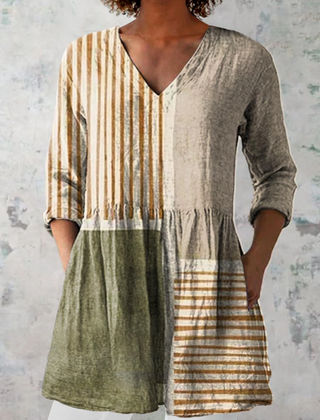 Long V-neck blouse with vertical stripes and olive green gathered skirt.