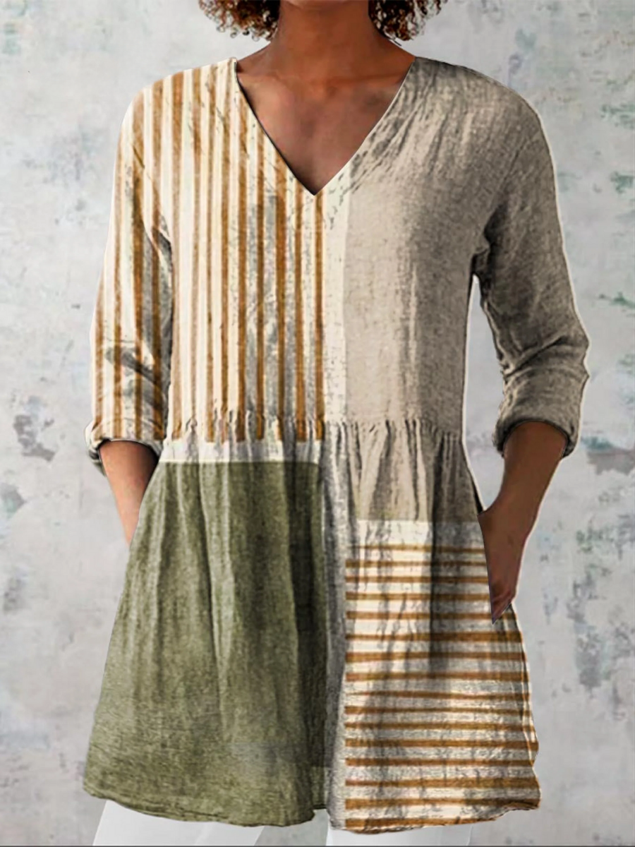 Long V-neck blouse with vertical stripes and olive green gathered skirt.