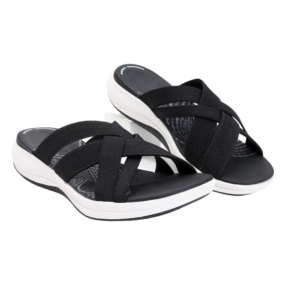 Black orthopedic comfort sandals with crisscross elastic straps and white cushioned sole.