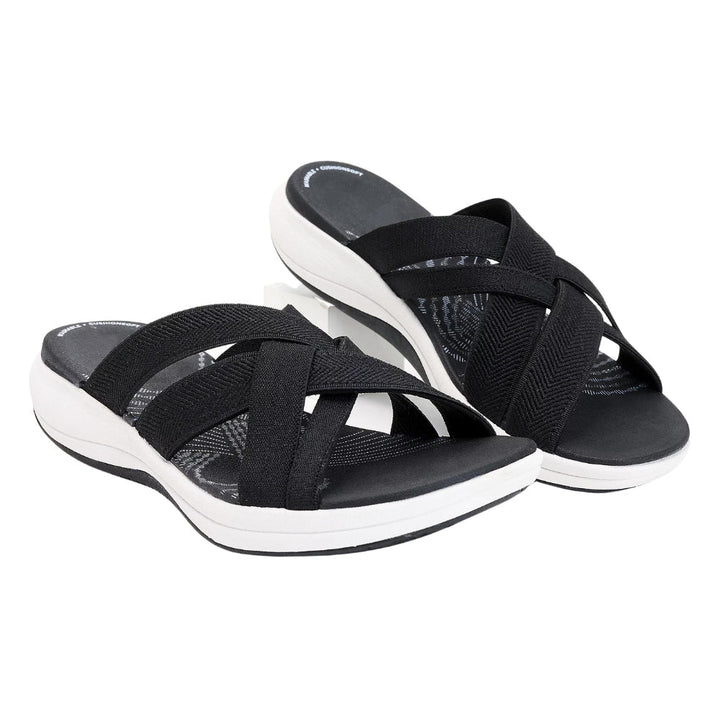 Black orthopedic comfort sandals with crisscross elastic straps and white cushioned sole.