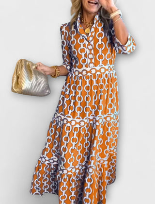 Orange chain-print midi dress with short sleeves and tiered skirt