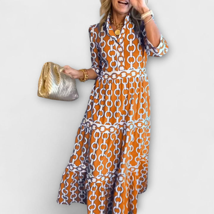 Orange chain-print midi dress with short sleeves and tiered skirt
