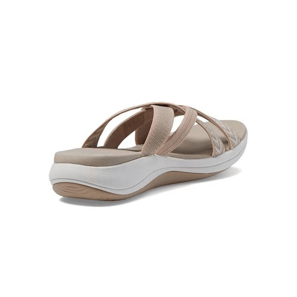 Beige orthopedic comfort sandals with padded straps and contoured sole, side view.