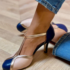 Dark blue pointed-toe heels with thin ankle strap and stiletto heel